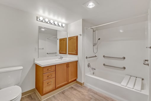 a bathroom with a shower sink and toilet and a mirror