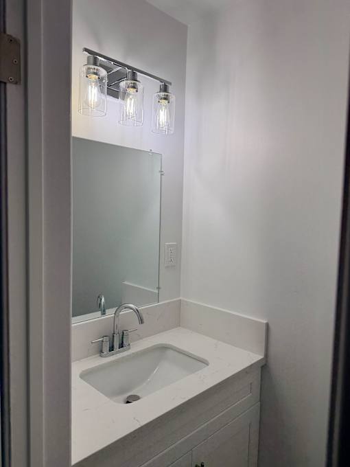 A bathroom sink with a mirror above it.