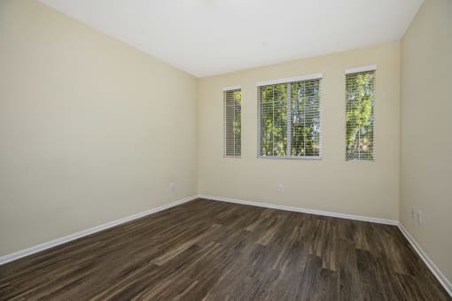 Parkside Villas unfurnished bedroom with wooden floors and window