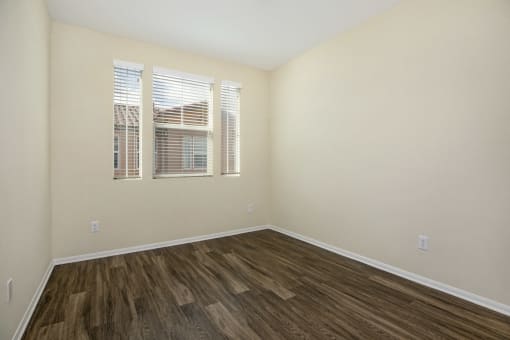 Parkside Villas unfurnished bedroom with wooden floors and window