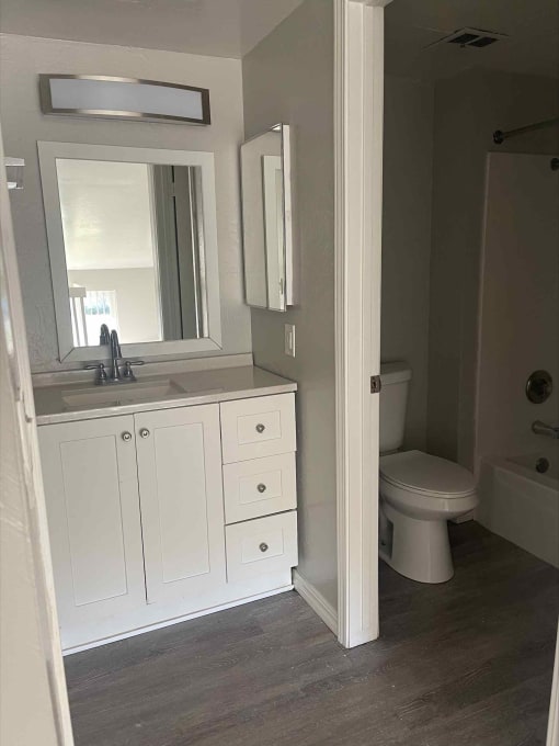 a bathroom with a sink toilet and shower