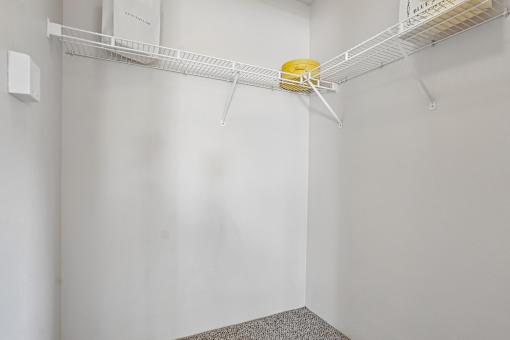A white shelf with a yellow object on it.