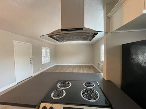 A modern kitchen with a stove top oven and a range hood.