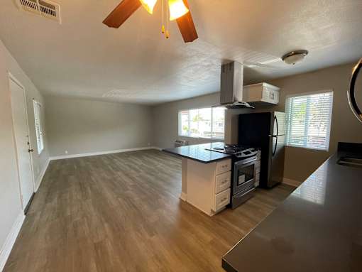 A kitchen with a stove top oven and a microwave.