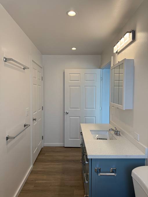 Pacific Oasis bathroom with a white sink and blue cabinet.