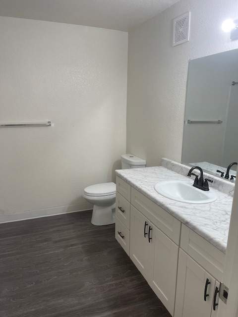 A white bathroom with a toilet and sink.