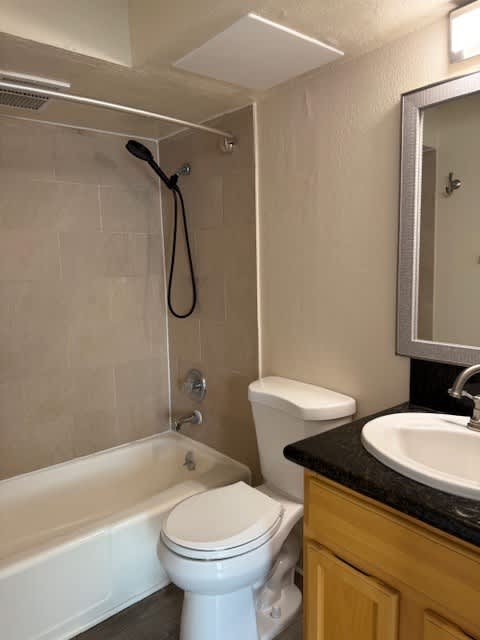 Napili Towers bathroom with a toilet, sink, and bathtub.