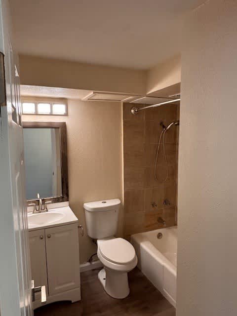 Napili Towers bathroom with a toilet, sink, and bathtub.