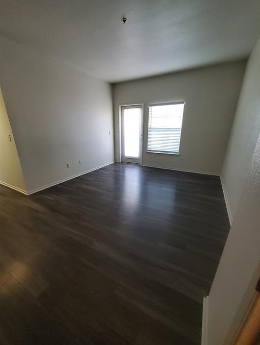 A room with wooden floors and a window.