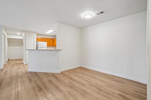 A room with wooden flooring and white walls.