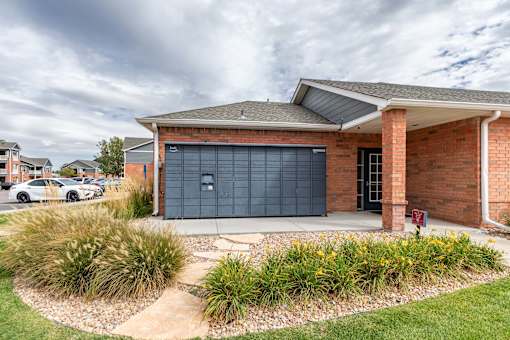 A red brick house with a black garage door.