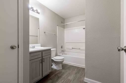 A small bathroom with a toilet, sink, and bathtub.