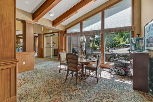 a dining room with a table and chairs and a window