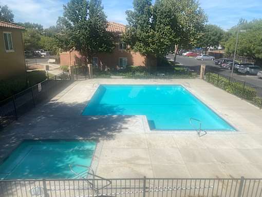 A small pool with a fence around it.