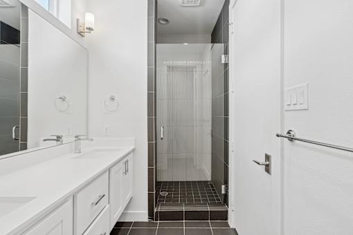 A white bathroom with a walk in shower.