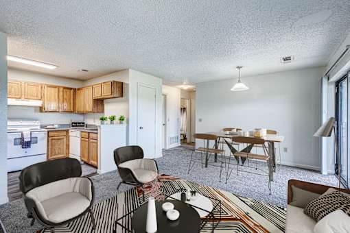 A living room with a sofa, a dining table, and chairs.