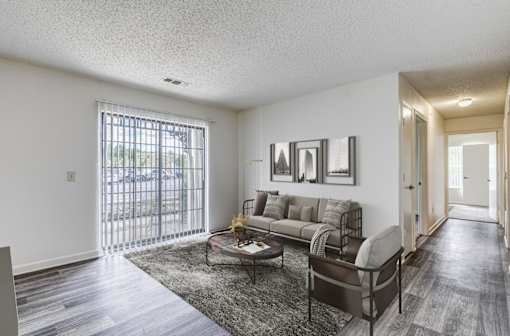 A living room with a grey couch and a coffee table.