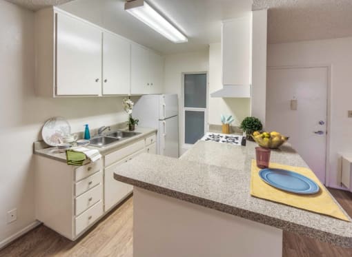 a kitchen with white cabinets and a counter top