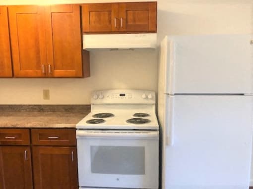 The Waterfront Apartments at Kahului kitchen area with gas stove, cabinets, and counters