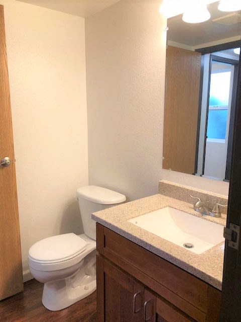The Waterfront Apartments at Kahului bathroom sink, mirror, vanity, and toilet