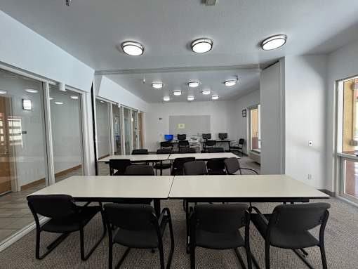 A conference room with a long table and chairs.