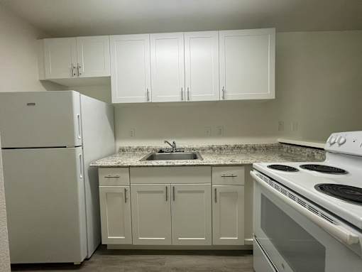Cluster Park kitchen with white appliances and cabinets.