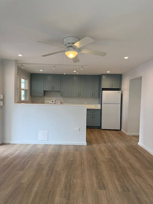 Pacific Oasis kitchen with a white counter and a ceiling fan.