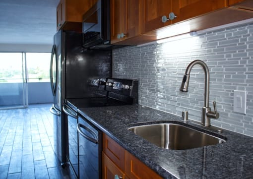 Napili Towers kitchen area with appliances, cabinets, and counters