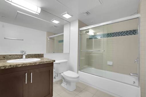 A bathroom with a sink, toilet, and bathtub.