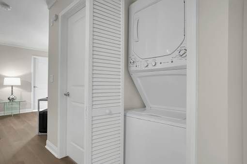 A white washing machine is in a small room.