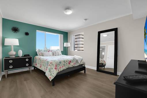 A bedroom with a bed, dresser, and mirror.