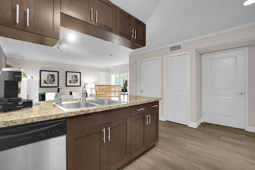 A kitchen with brown cabinets and a black stove top oven.