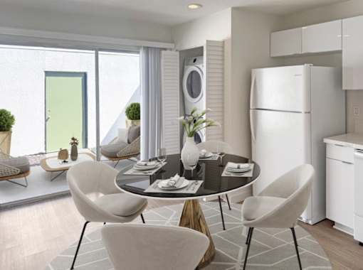 A modern dining room with a round table and chairs.