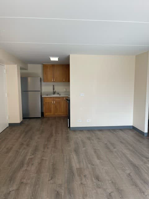 Napili Towers kitchen with a refrigerator, cabinets, and a counter.