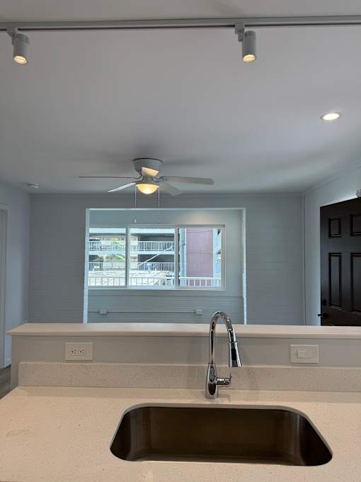 Pacific Oasis kitchen with a stainless steel sink and a ceiling fan.