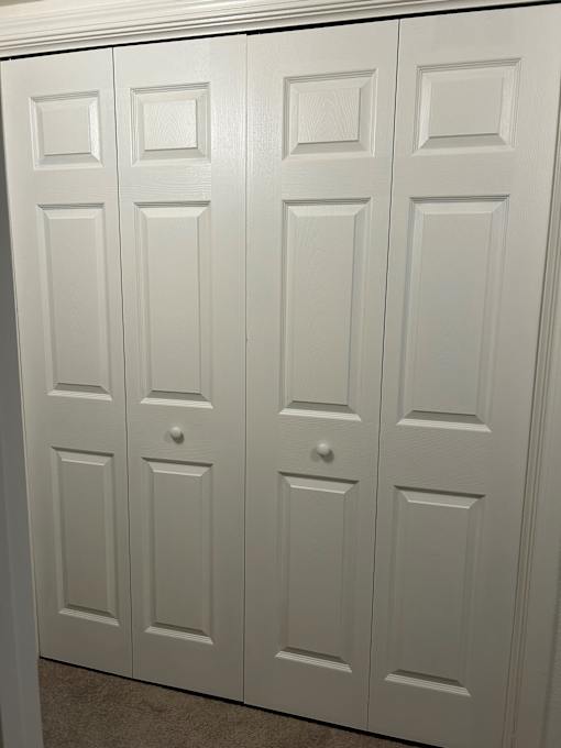 A set of white double doors with panels.