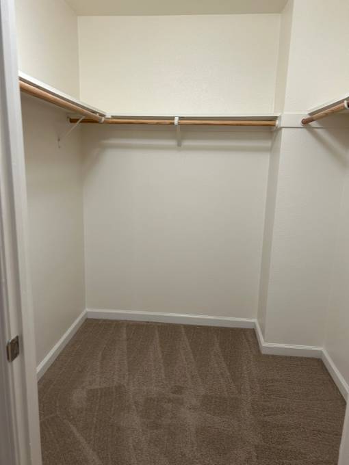 A white shelf with a copper pipe on the left side.