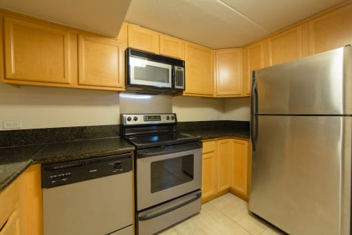 Napili Towers kitchen area with appliances, cabinets, and counters