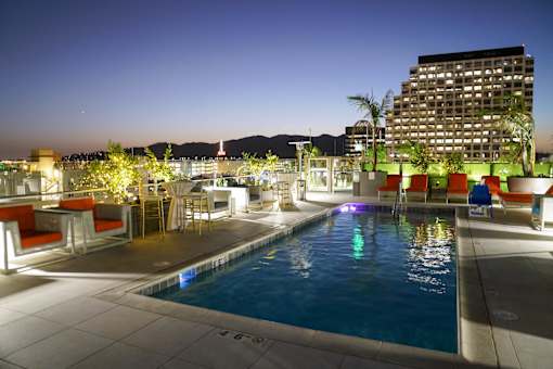 Maia Avira Rooftop Pool at Dusk