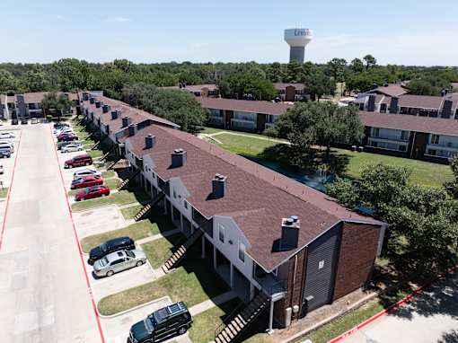 A long building with a water tower in the background.