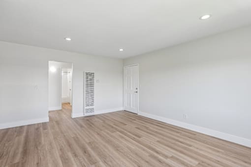 A room with white walls and wooden flooring.