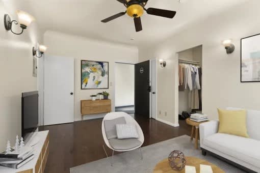 A living room with a white couch, a chair, and a coffee table.