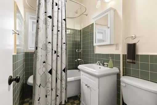 A white bathroom with a white tub and sink.