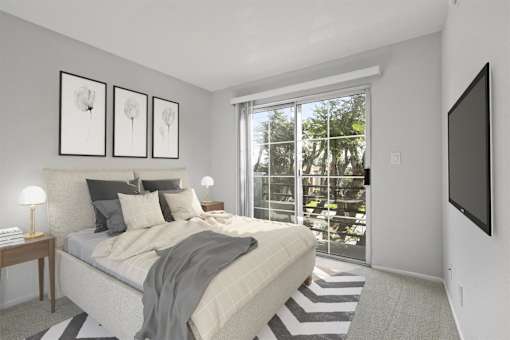 A bedroom with a large bed and a flat screen TV mounted on the wall.