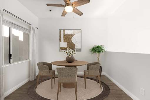 A dining room with a table and chairs.