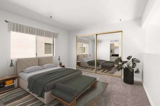 A bedroom with a large bed and a mirror on the wall.