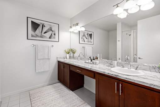 A bathroom with a white sink and a mirror.
