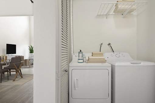 A white washing machine and dryer in a laundry room.