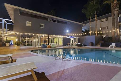 A modern building with a pool in front.