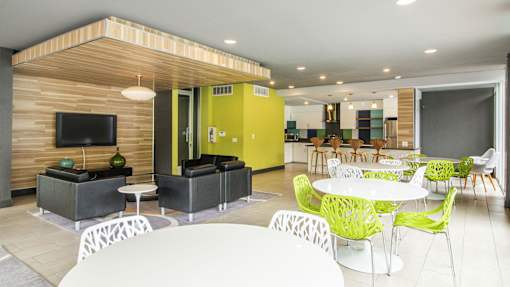 A modern living room with a wooden accent wall and a variety of seating options.